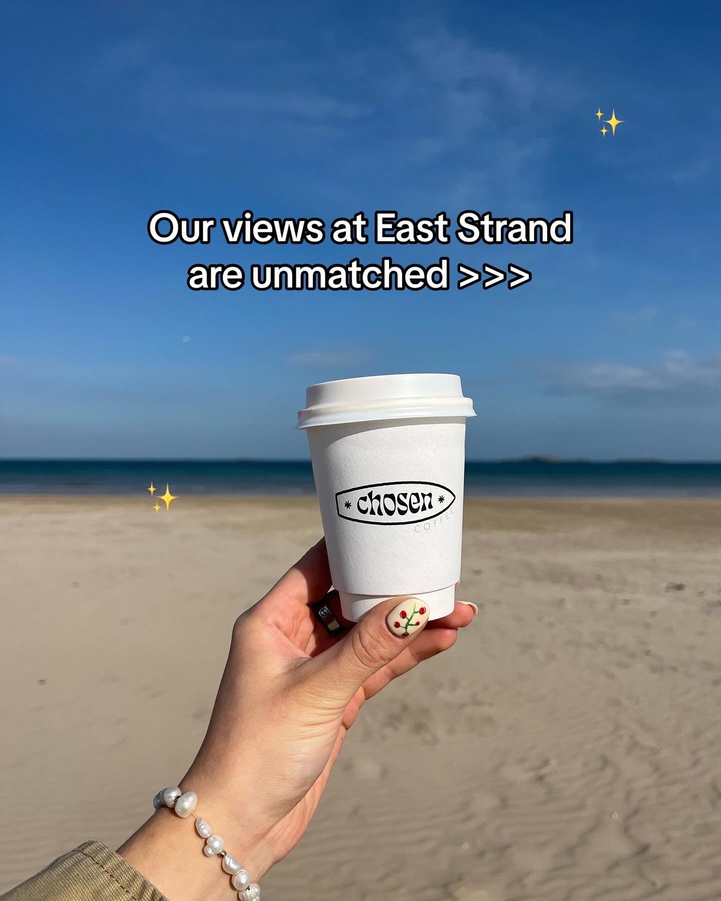 Story slide 4: a Chosen Coffee cup held up in front of East Strand beach